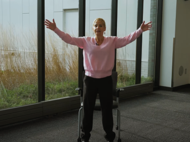 woman standing and extending arms out like a star